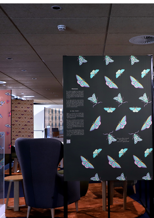 Dim lighting over an exhibition with tall standing separators covered in moths