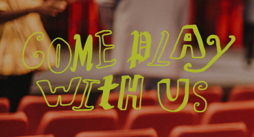 text "Come play with us" on photograph of a theatre 