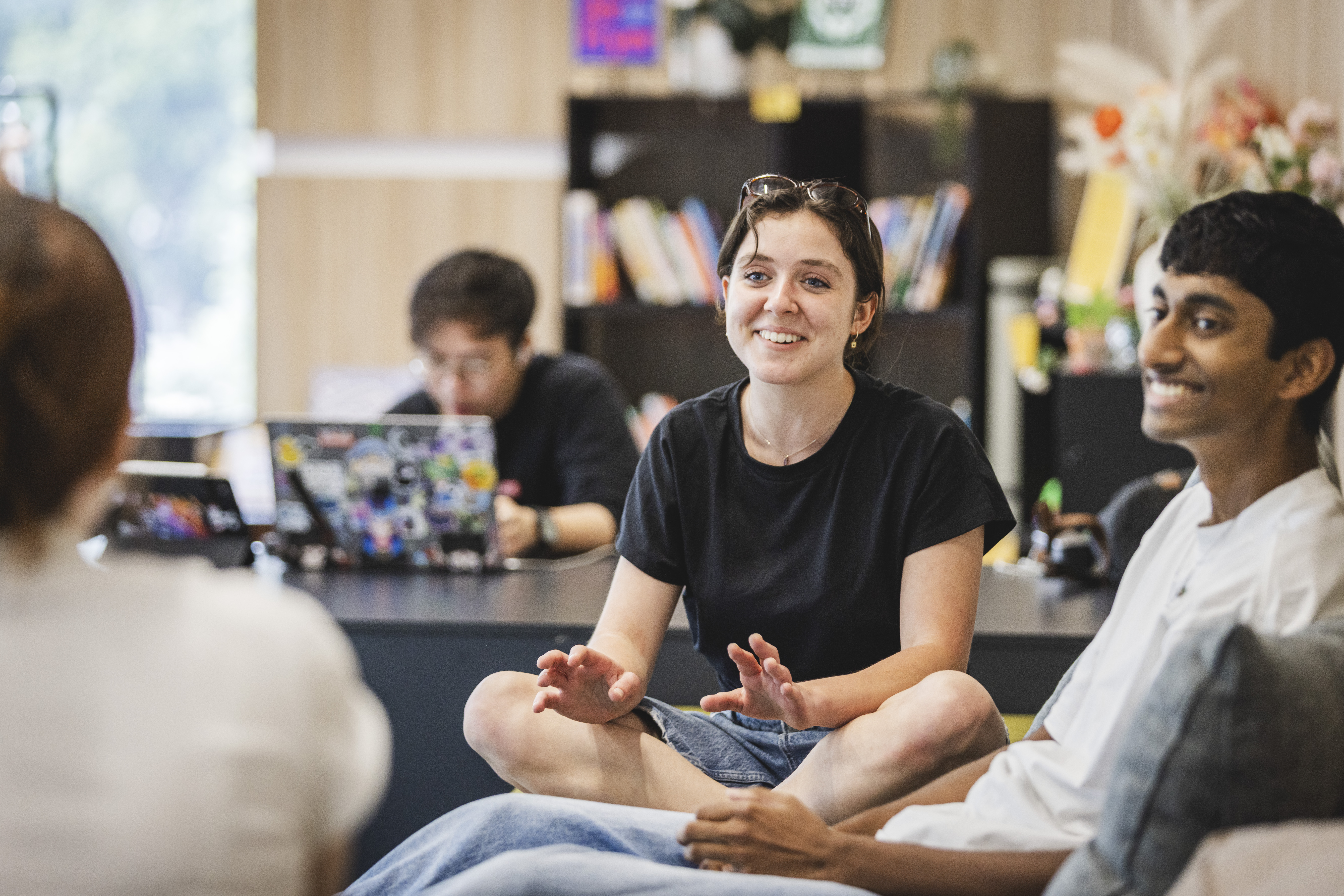 Students sitting and laughing in the Wellbeing Lounge