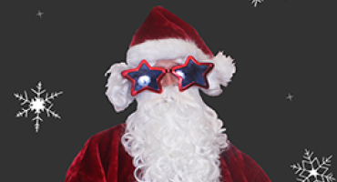 Santa wearing star shaped glasses against a charcoal background with white snowflakes.