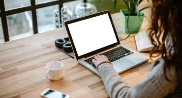 Woman typing at laptop