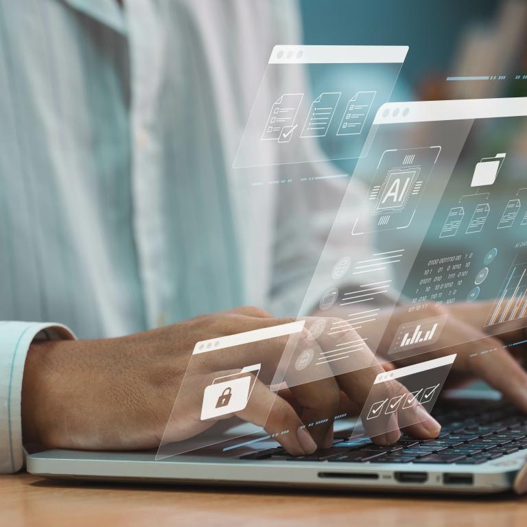 Hands hovering over laptop to type with an imposed floating screen display