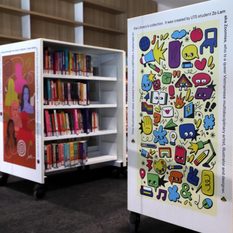 Photograph of bookshelves with bright artworks on the ends