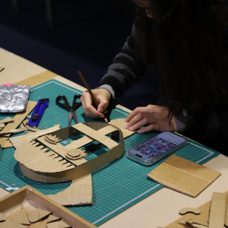 Hands making a carboard mask