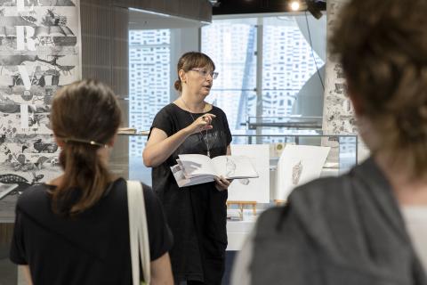 Donna Sgro talking in exhibition space