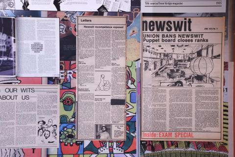 Exhibition wall with archival Newswit spreads